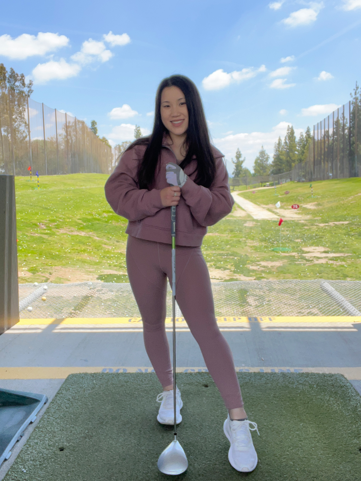 Golfer Holding Golf Club and a Louis Vuitton Bag