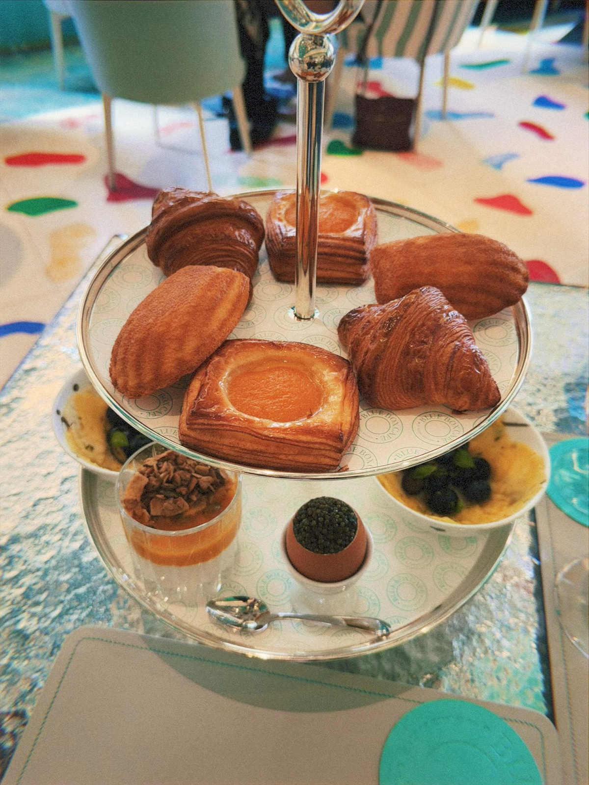 Tiffany's Blue Box Cafe croissant, madeline, pineapple rosace, oranais, oeuf brouille, and parfait maison